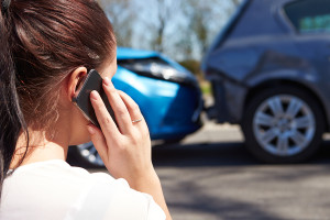 Stressed Driver Sitting At Roadside After Traffic Accident