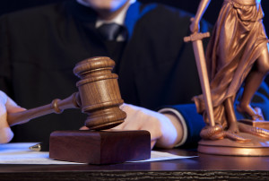 Judge. Male judge in a courtroom striking the gavel