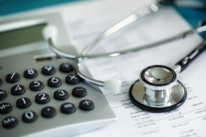 Calculator and stethoscope on financial statement concept for fi