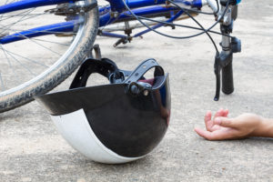 Bicycle And A Helmet Lying On The Road With Hand Of Human, Accid